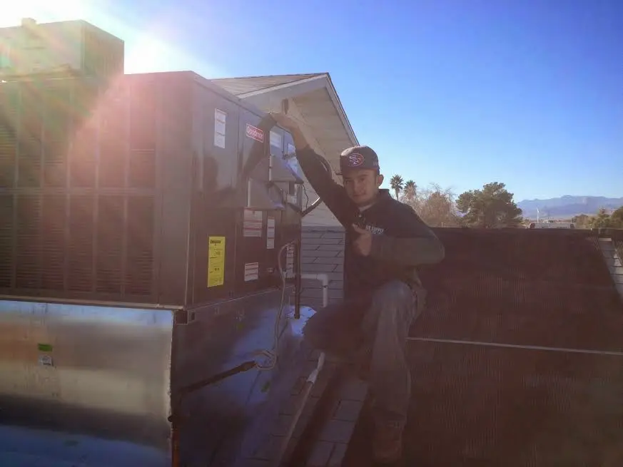 HVAC technician performing HVAC Inspection on a rooftop unit in Lynden